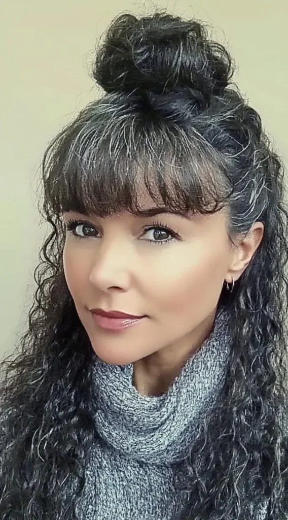 15 Best Hairstyles with Bangs for Women Over 40 with Long Hair (Look Instantly Younger) Hairstyles with Bangs for Women Over 40:Curly Half-Up Bun with Blunt Bangs for Women Over 40